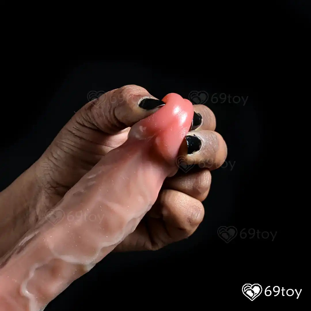 Hand holding a silicone Realistic  dildo  glance in  a black background with '69toy' branding.