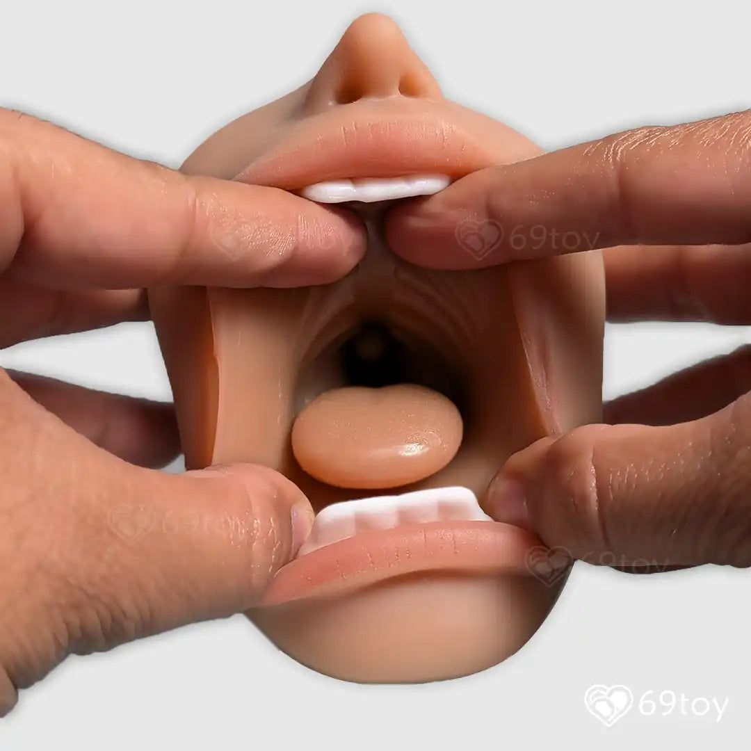 Realistic silicone model of a female mouth for sucking  held by hands on a white background.