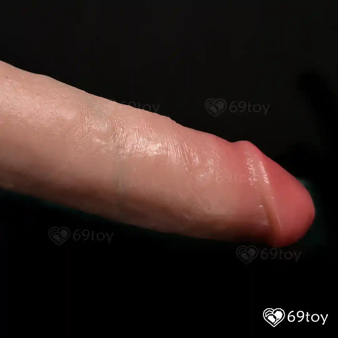 Close-up of a sexual product  with visible skin texture on a black background